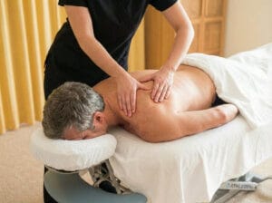 Therapist providing calm, full back relaxation massage to support nervous system regulation.